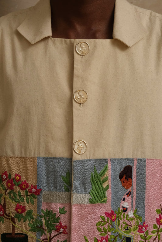 Fontainhas hand-embroidered shirt, wearable art in unbleached cotton. Documentary style hand embroidery. Garlic Moon Silver Insignia Buttons. Latin Quarters. Archival Clothing.