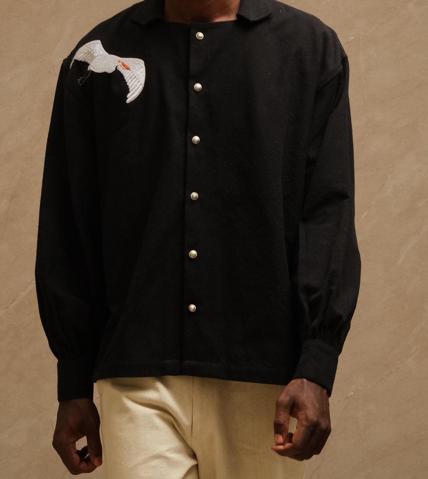 Sambhar 1.0 hand embroidered art shirt exploring pastoral landscapes through threadwork, shepherd imagery, grazing sheep motifs, and slow crafted textile storytelling shaped into a one of one wearable artwork. 