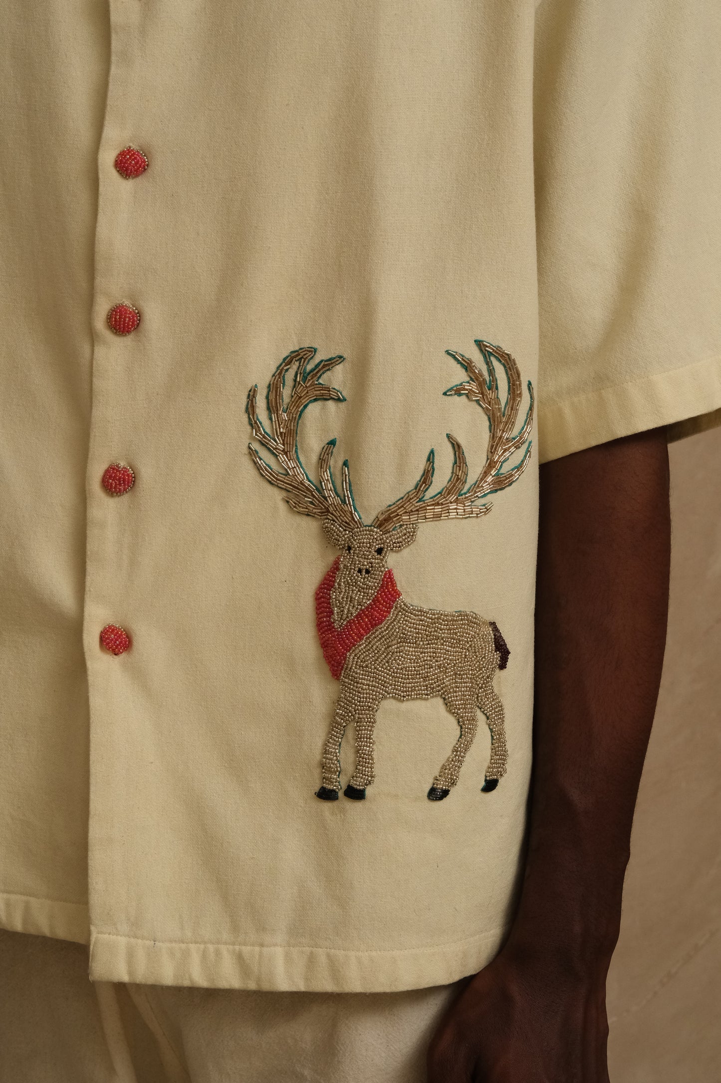 Close study of the Barasingha embroidered shirt revealing layered threadwork, handcrafted wildlife detailing, and one of one collector level textile artistry
