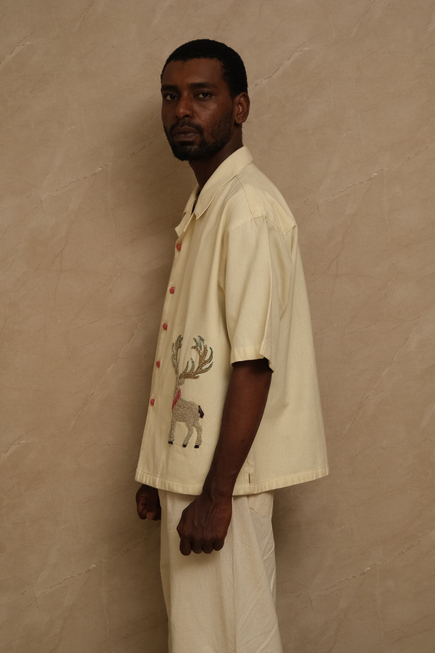 Hand embroidered Barasingha collector shirt showcasing deer inspired motifs, textured cotton fabric, artisanal stitching, and heritage inspired wearable textile craftsmanship