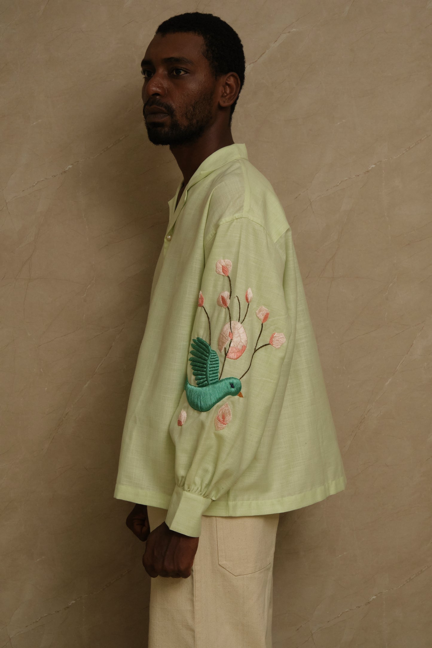 Detailed close up of Hiral Parind embroidery showing handcrafted satin stitching, textured silk surface, bird inspired motifs, and collector focused textile craftsmanship