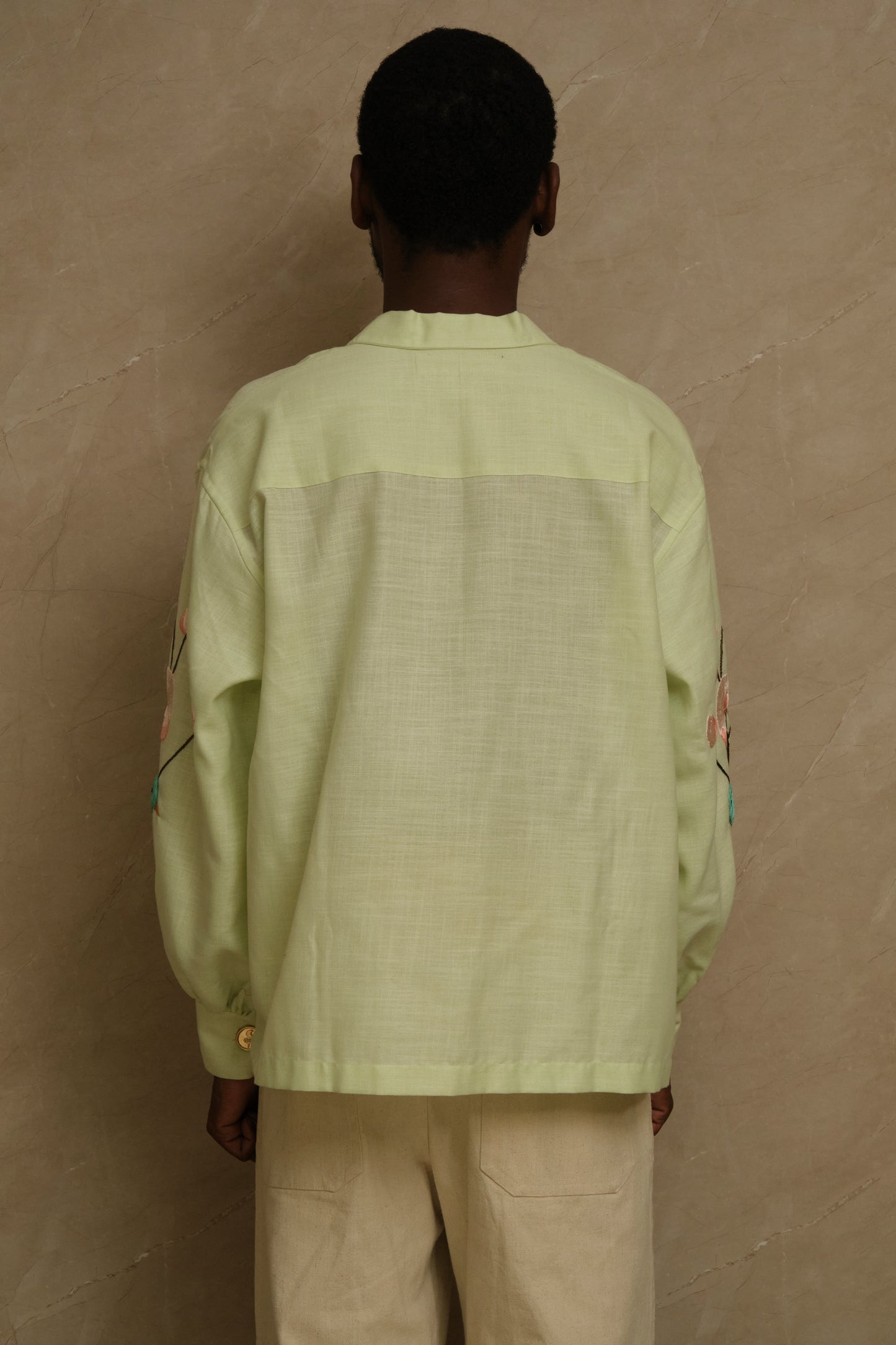 Hiral Parind one of one hand embroidered silk shirt featuring birds in flight, layered satin stitch embroidery, pearl buttons, and slow crafted collector focused wearable artwork
back view