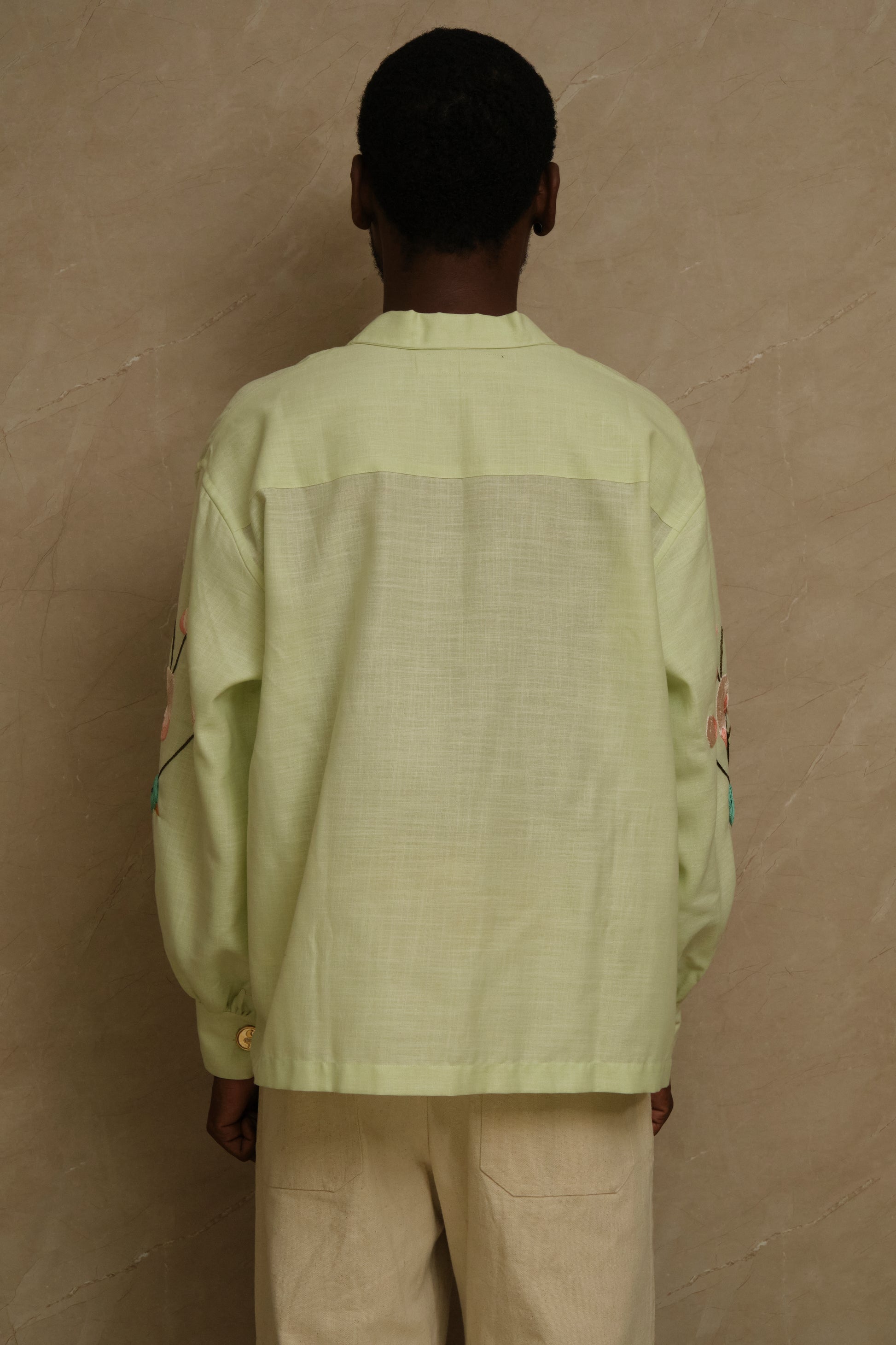 Hiral Parind one of one hand embroidered silk shirt featuring birds in flight, layered satin stitch embroidery, pearl buttons, and slow crafted collector focused wearable artwork
back view