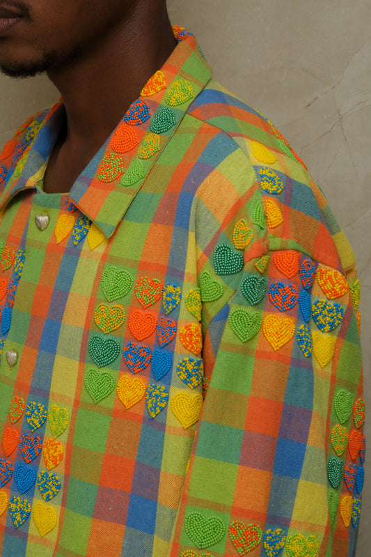 Handcrafted Mirage wearable artwork showcasing intricate bead embroidery, textured checkered fabric, artisanal ornamentation, and vintage inspired textile craftsmanship photographed editorially