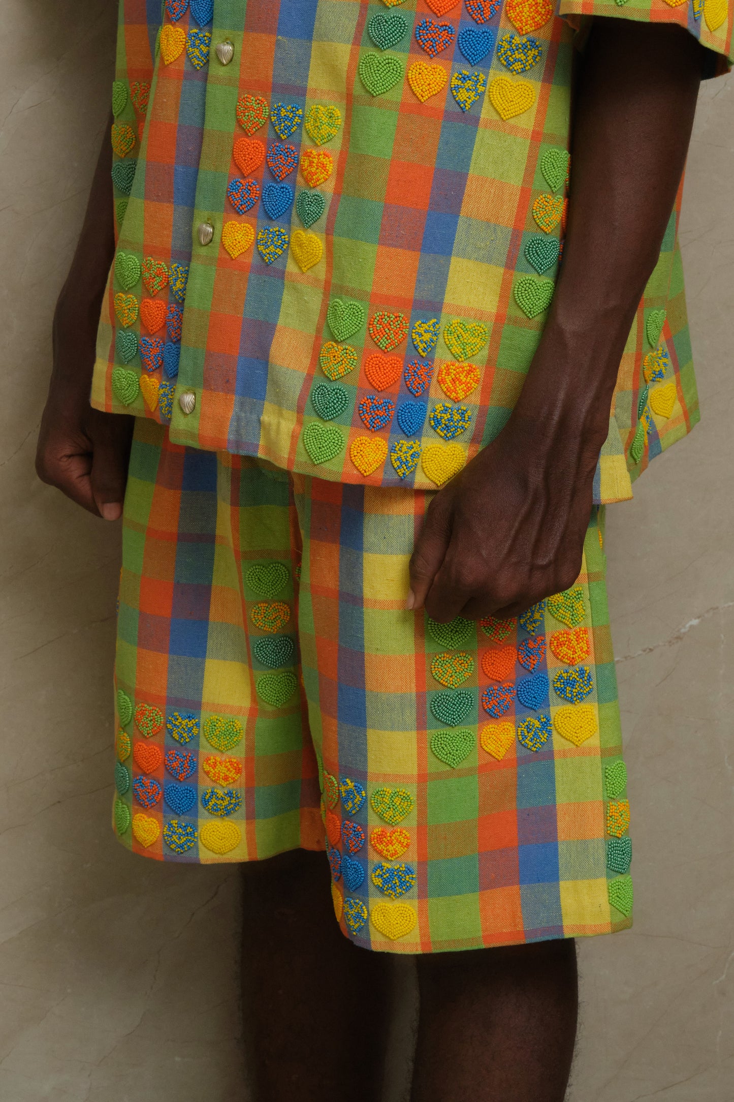 Mirage Shorts one of one handcrafted artwear piece featuring checkered textile construction, heart shaped bead embroidery, and slow crafted collector focused detailing