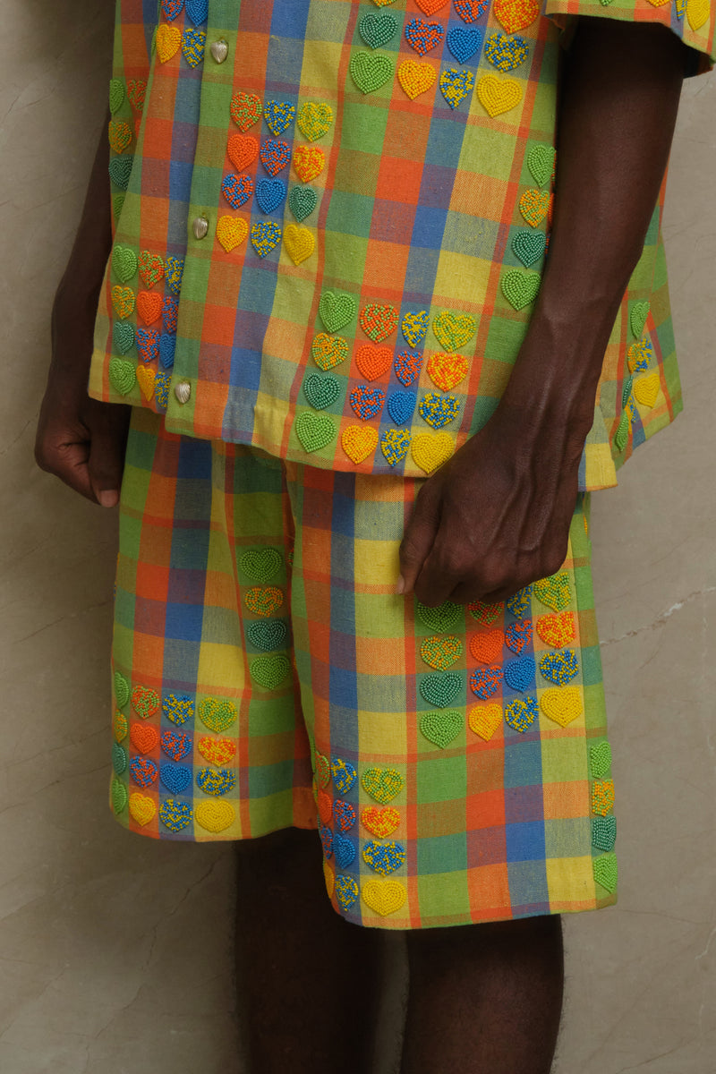 Mirage Shorts one of one handcrafted artwear piece featuring checkered textile construction, heart shaped bead embroidery, and slow crafted collector focused detailing