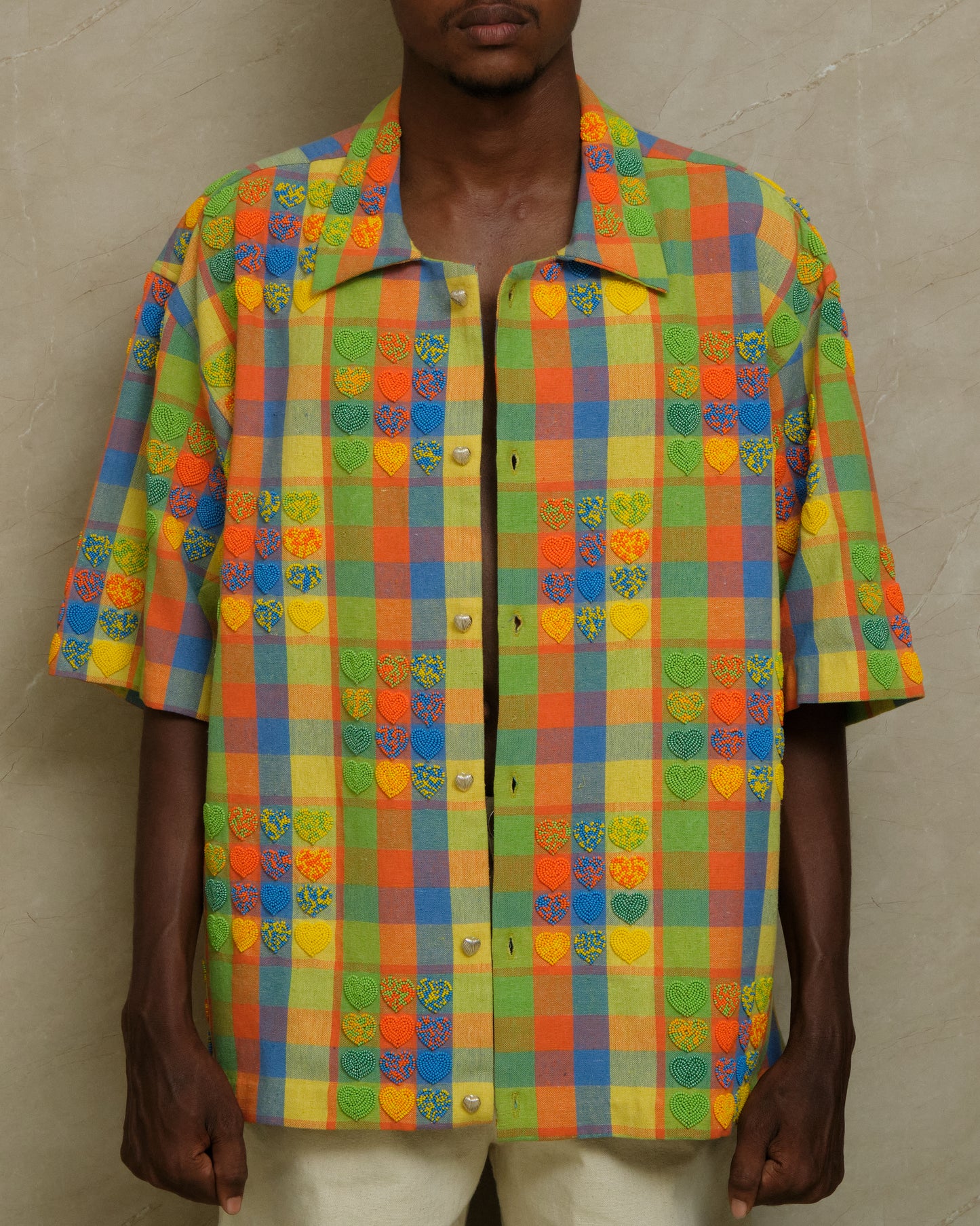 Front view of the Mirage hand embroidered shirt featuring detailed beadwork, checkered textile layering, artisanal surface treatment, and slow crafted wearable artwork