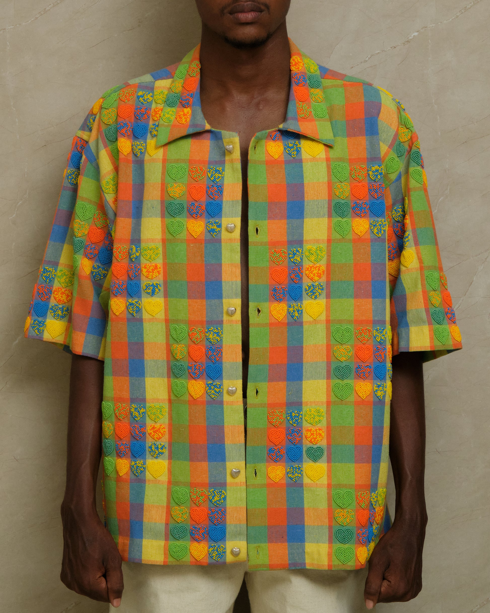 Front view of the Mirage hand embroidered shirt featuring detailed beadwork, checkered textile layering, artisanal surface treatment, and slow crafted wearable artwork