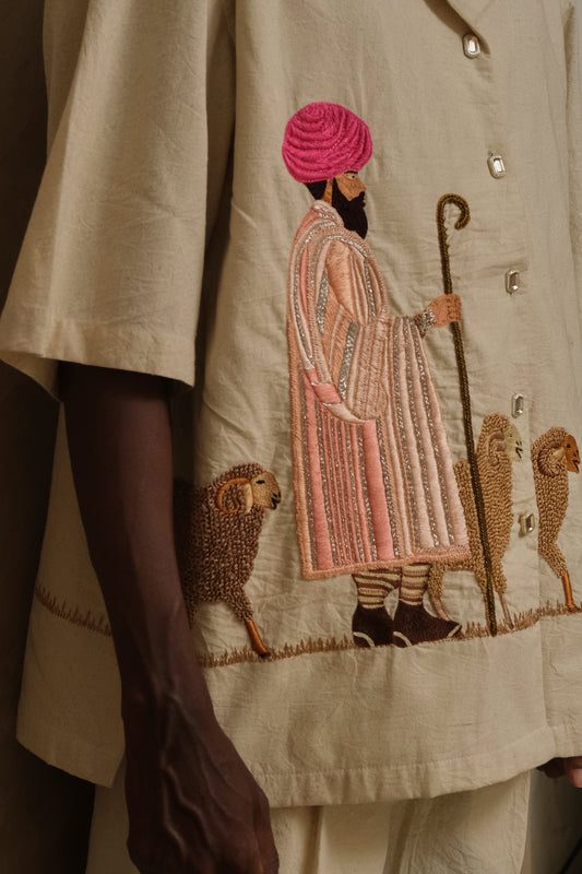 Detailed close up of Sambhar 2.0 showing layered embroidery techniques, silver toned buttons, handcrafted threadwork, and slow textile artistry shaped into wearable art